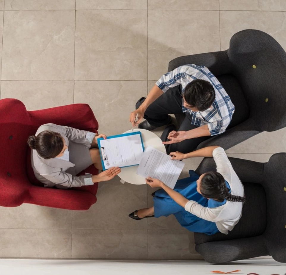 A group of people sitting around each other.