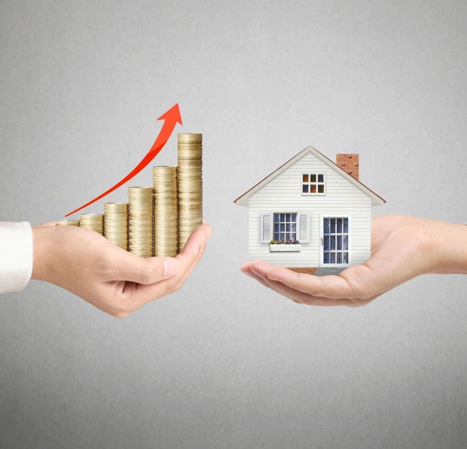 A couple of hands holding up coins and a house.